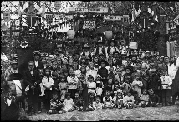 Een grote groep kinderen poseert in de versierde Isaäc Hubertstraat 1923.