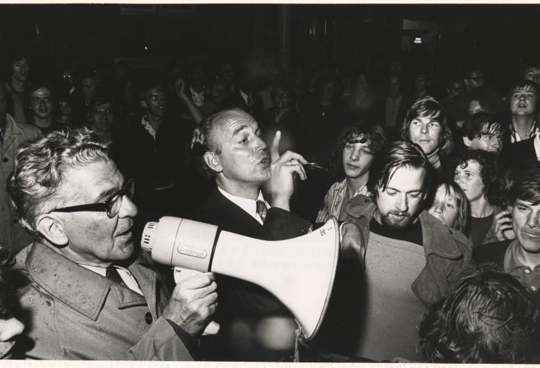 11 augustus 1972: Burgemeester Thomassen bezoekt de Afrikaanderwijk na de rellen tussen bewoners. In augustus ontaardde een huurconflict tussen een Turkse verhuurder en een Nederlandse huurder in de Afrikaanderwijk in Rotterdam-Zuid in een soort volkswoede. Vechtpartijen breken uit en bezittingen van de Turkse bewoners worden vernield. Dagenlang zijn de gemoederen verhit, ondanks de aanwezigheid van oproerpolitie en burgemeester Thomassen die de bewoners probeert te kalmeren. Fotograaf: Peter Molkenboer. Co